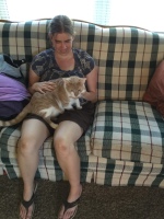 Fallon and Minion Fallon holding a large orange cat. Both facing camera.